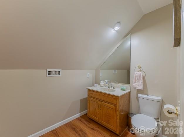 3131 Christie Road Hudson, NC 28638 - Photo 40 of 48 a bathroom with a sink toilet vanity and wooden floor