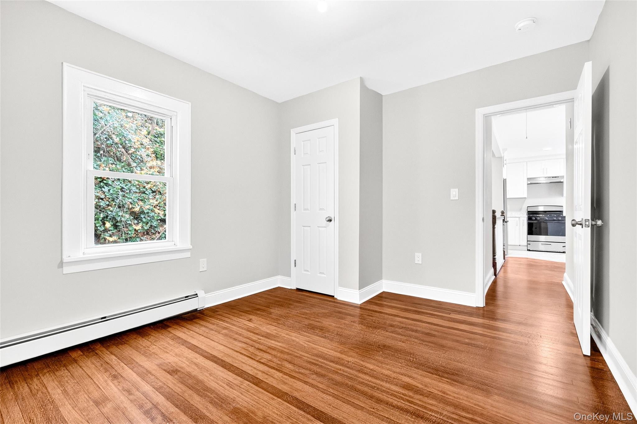 669 North Division Street Peekskill, NY 10566 - Photo 14 of 48 an empty room with wooden floor and windows