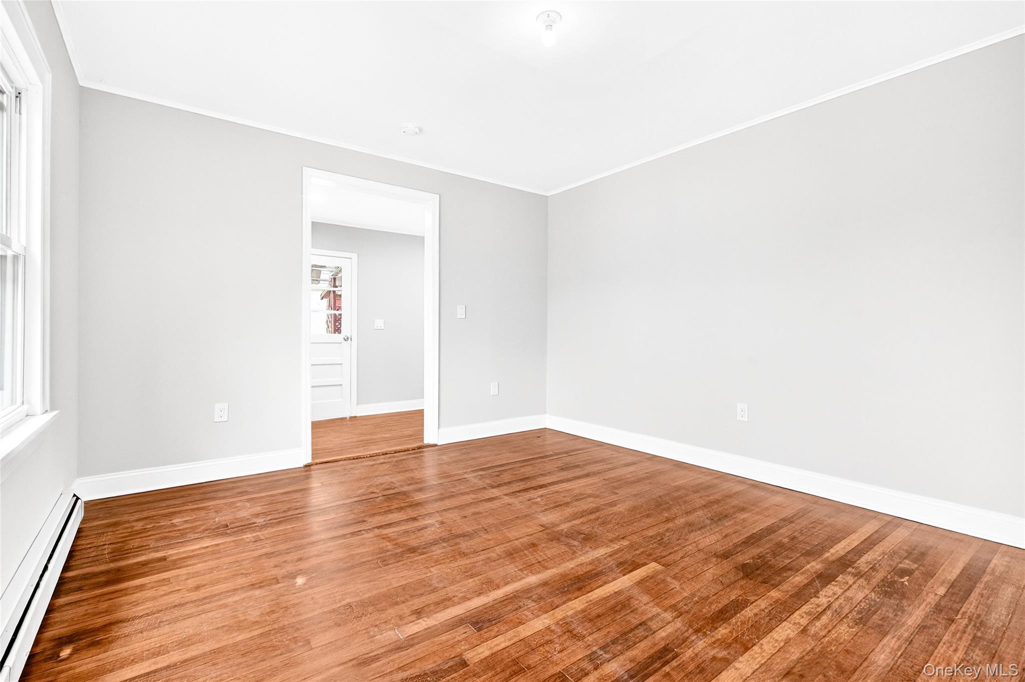 669 North Division Street Peekskill, NY 10566 - Photo 17 of 48 a view of an empty room with wooden floor