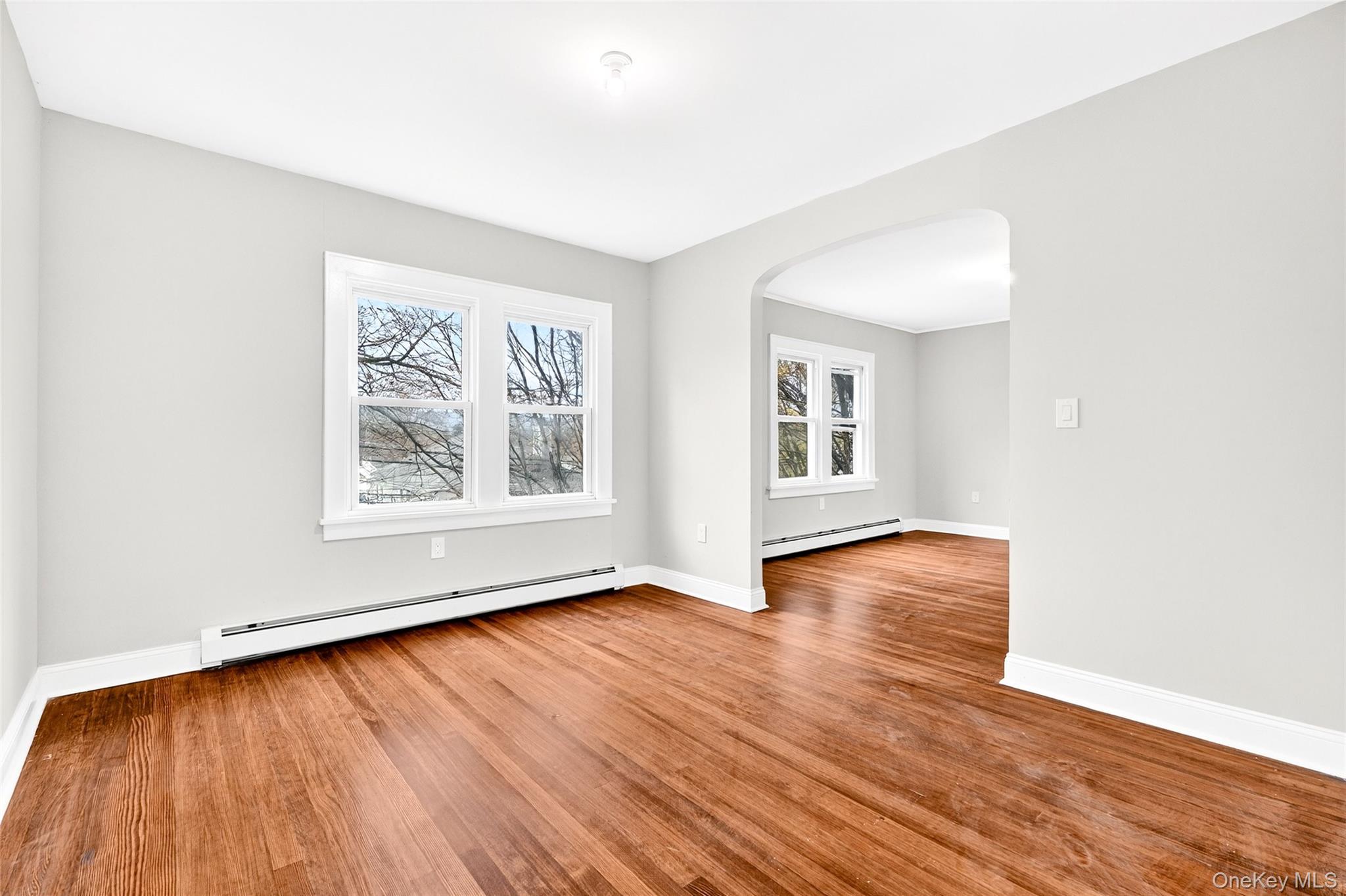 669 North Division Street Peekskill, NY 10566 - Photo 21 of 48 an empty room with wooden floor and windows