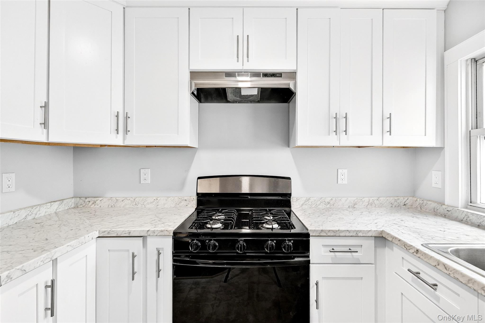 669 North Division Street Peekskill, NY 10566 - Photo 24 of 48 a kitchen with granite countertop white cabinets and stainless steel appliances