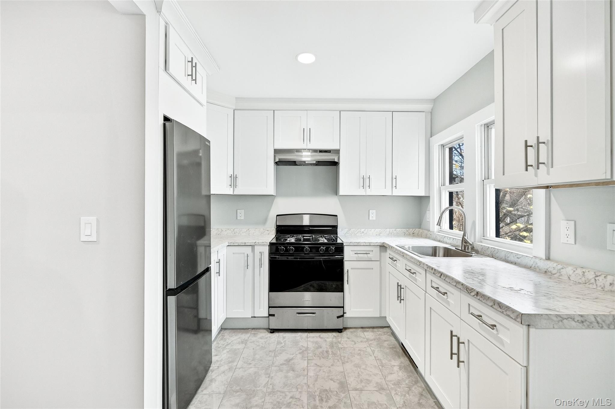 669 North Division Street Peekskill, NY 10566 - Photo 26 of 48 a kitchen with a stove sink and cabinets