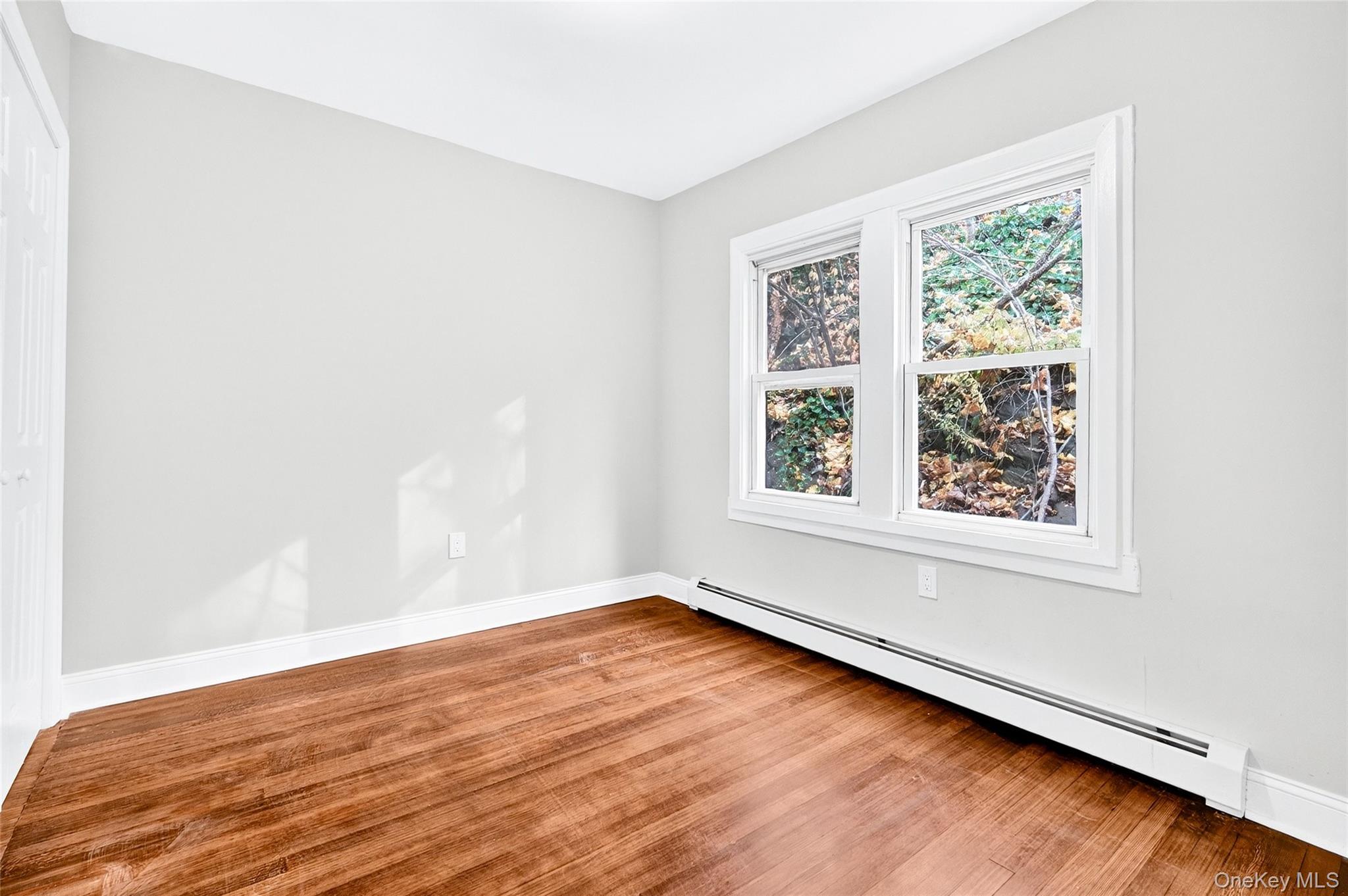 669 North Division Street Peekskill, NY 10566 - Photo 27 of 48 an empty room with wooden floor and windows