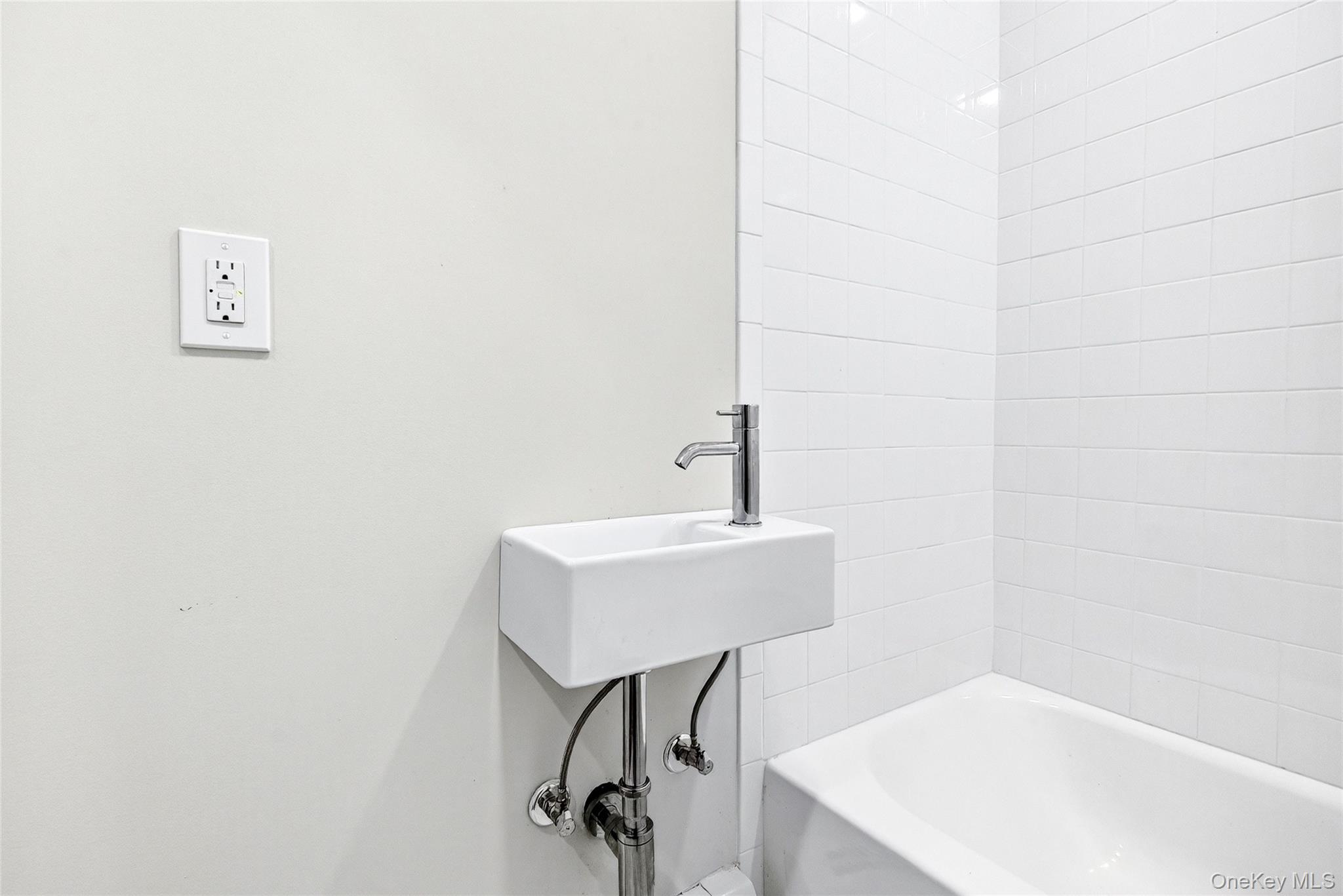 669 North Division Street Peekskill, NY 10566 - Photo 31 of 48 a bathroom with a sink and a mirror