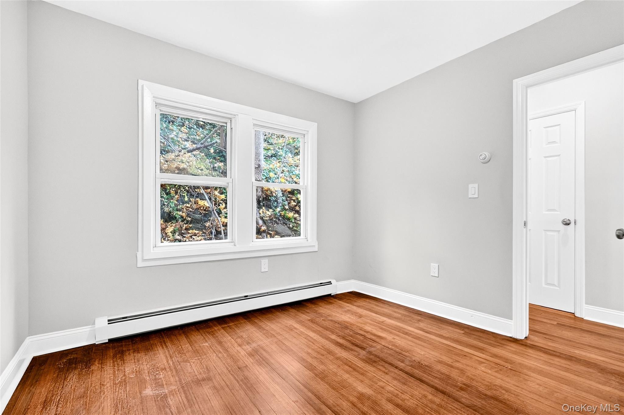 669 North Division Street Peekskill, NY 10566 - Photo 32 of 48 an empty room with wooden floor and windows