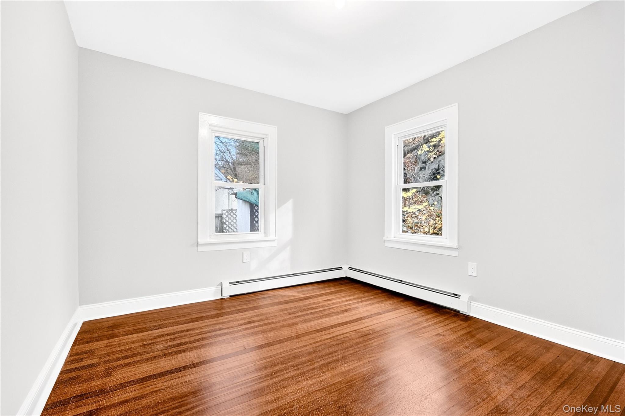 669 North Division Street Peekskill, NY 10566 - Photo 34 of 48 an empty room with wooden floor and windows