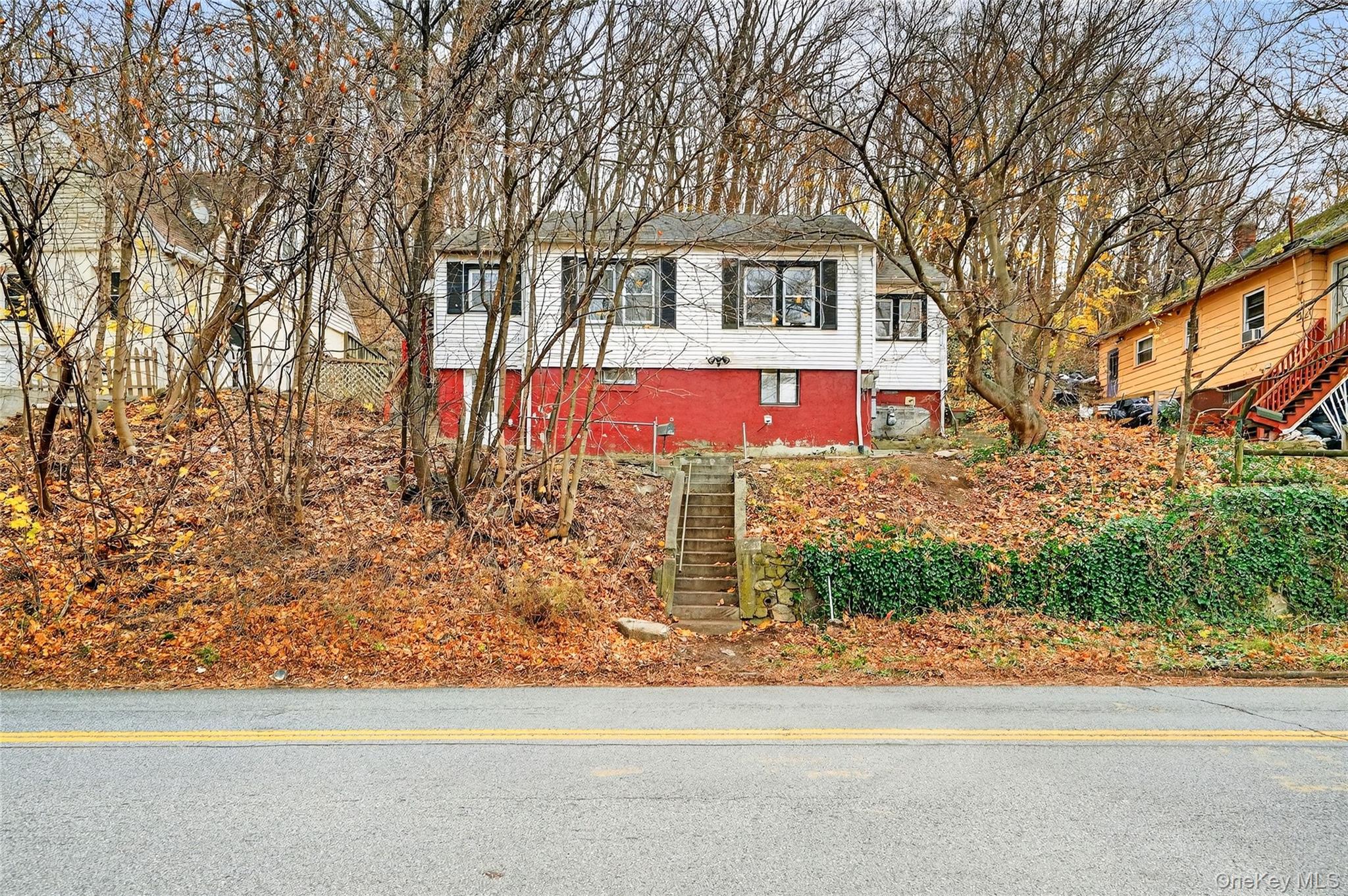 669 North Division Street Peekskill, NY 10566 - Photo 42 of 48 a view of a house with a yard and large tree