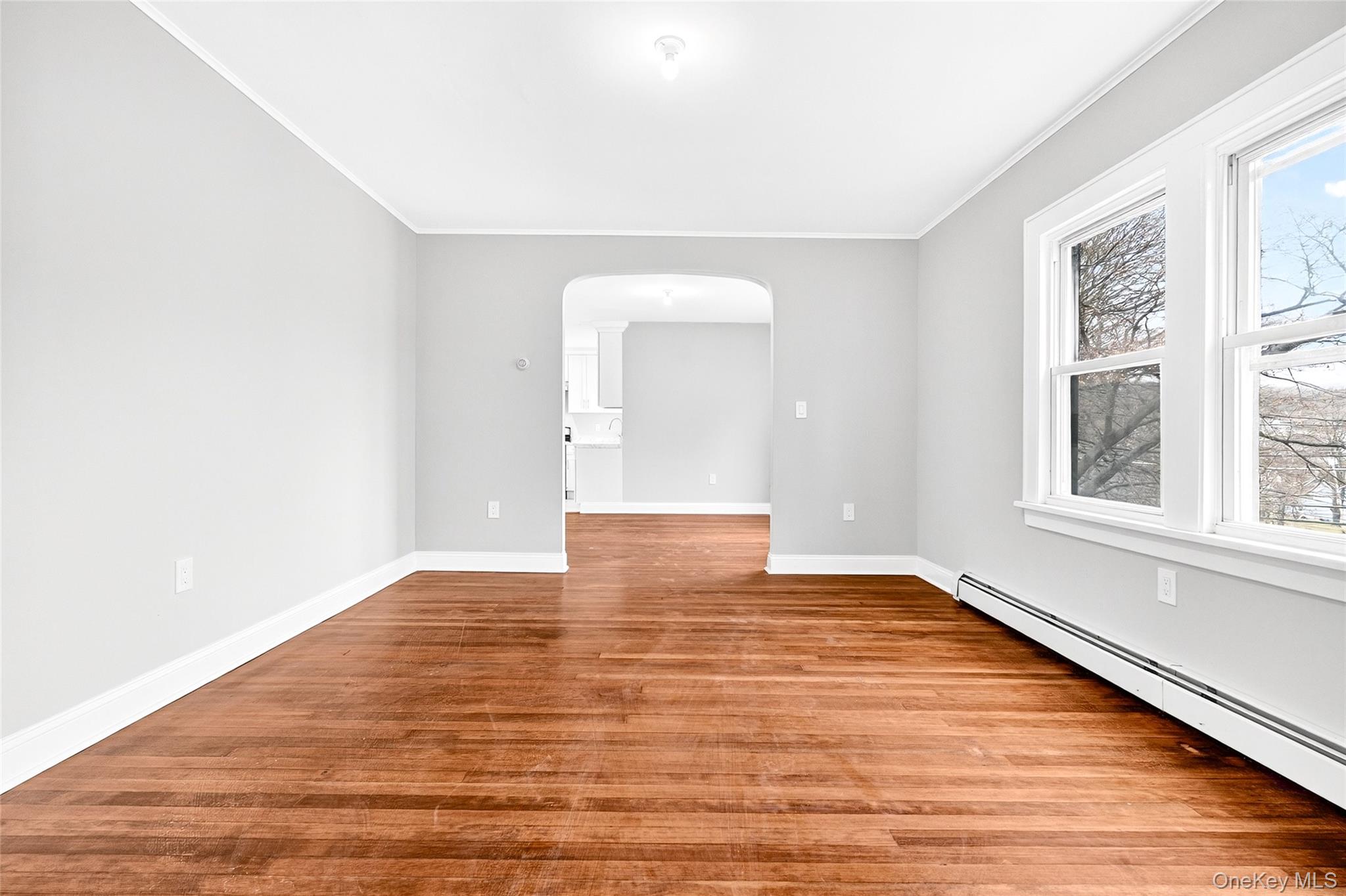 669 North Division Street Peekskill, NY 10566 - Photo 5 of 48 a view of an empty room with wooden floor and a window