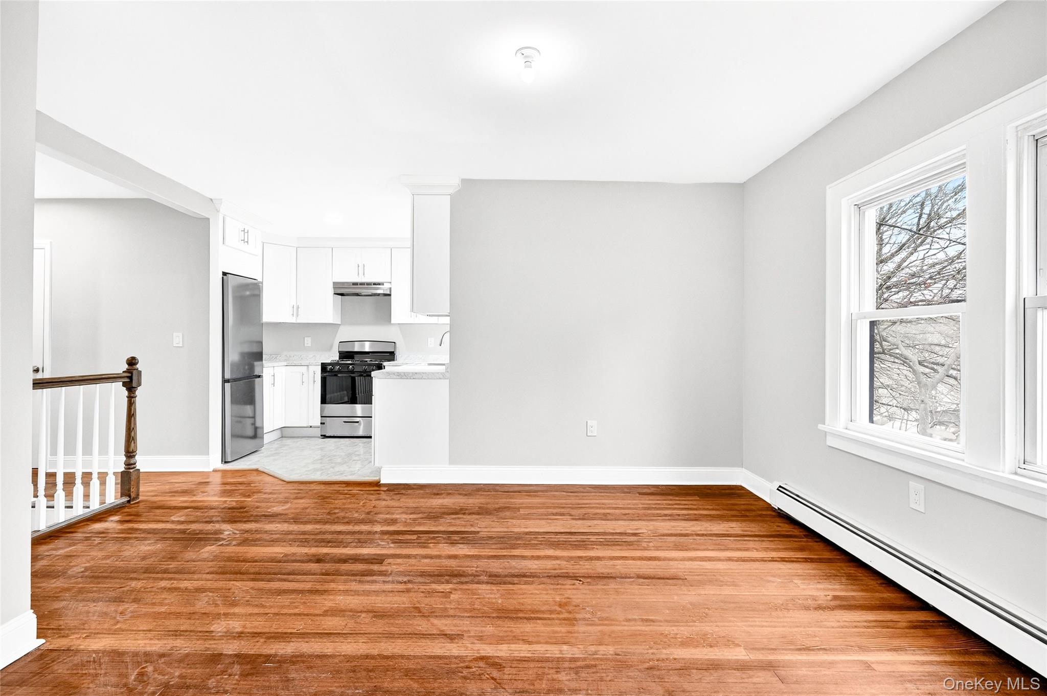 669 North Division Street Peekskill, NY 10566 - Photo 6 of 48 a view of a kitchen with wooden floor and white cabinets