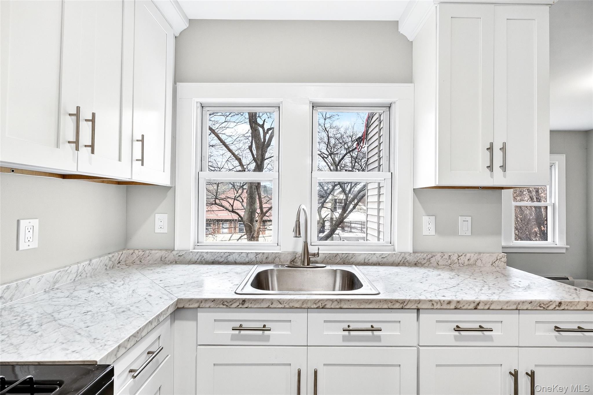 669 North Division Street Peekskill, NY 10566 - Photo 7 of 48 a kitchen with granite countertop white cabinets and a window