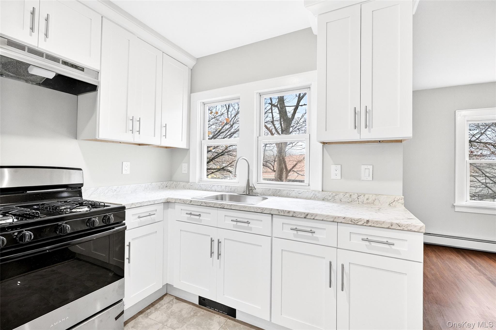 669 North Division Street Peekskill, NY 10566 - Photo 8 of 48 a kitchen with granite countertop white cabinets and appliances