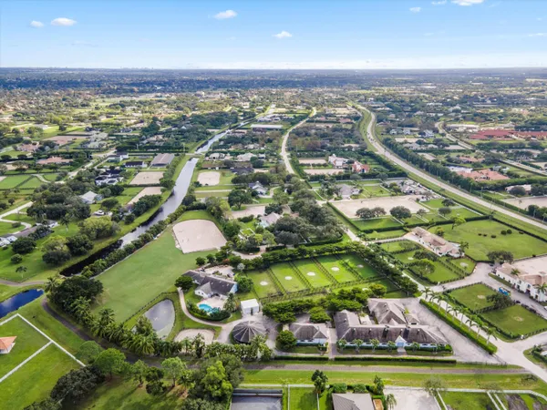 an aerial view of residential houses with outdoor space and swimming pool