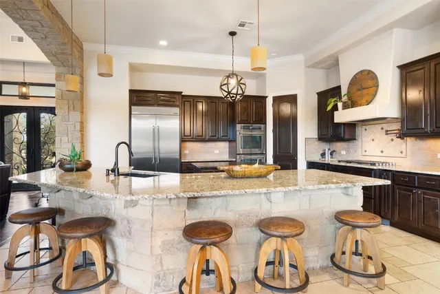 a large kitchen with a table and chairs