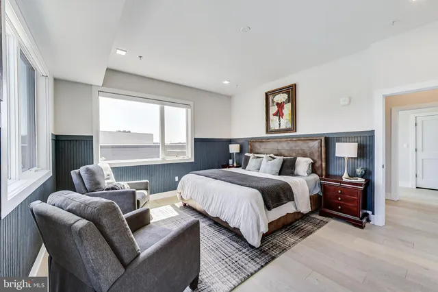 a spacious bedroom with a bed and a couch