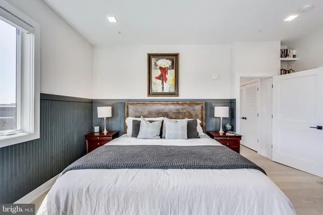 a bedroom with a large bed and a window