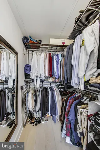 a view of walk in closet with clothes