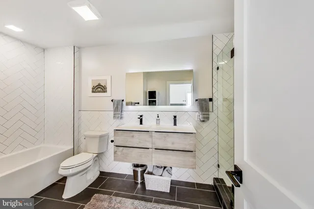 a bathroom with a sink toilet a mirror and shower