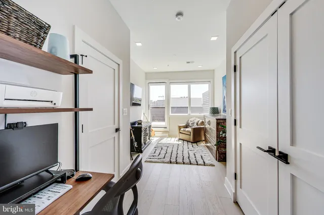 a view of a livingroom with furniture and a flat screen tv