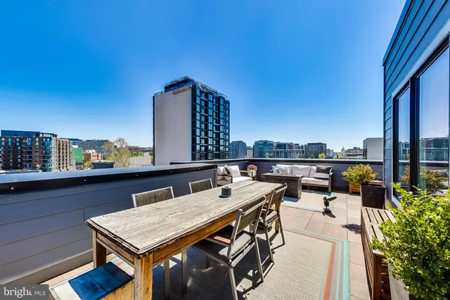a terrace with outdoor seating and city view