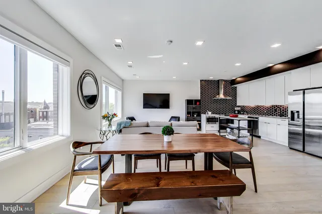 a view of a dining room with furniture and a large window