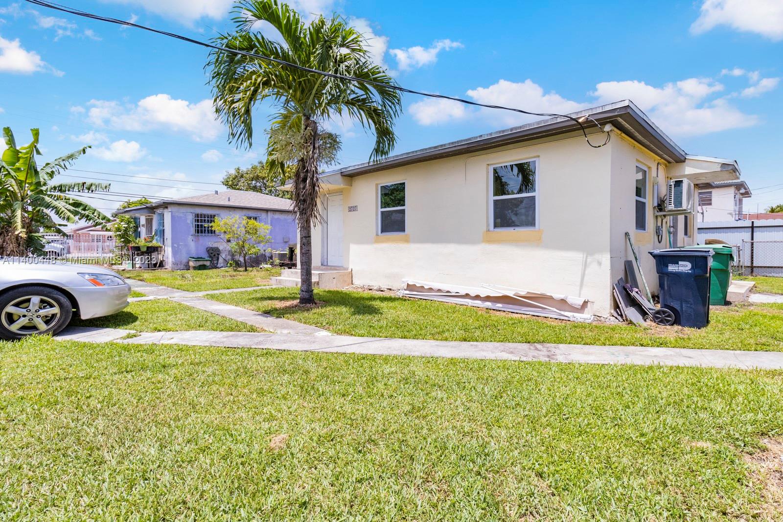 2990 Northwest 28th Street Miami, FL 33142 - Photo 1 of 13 a view of a house with swimming pool and a yard