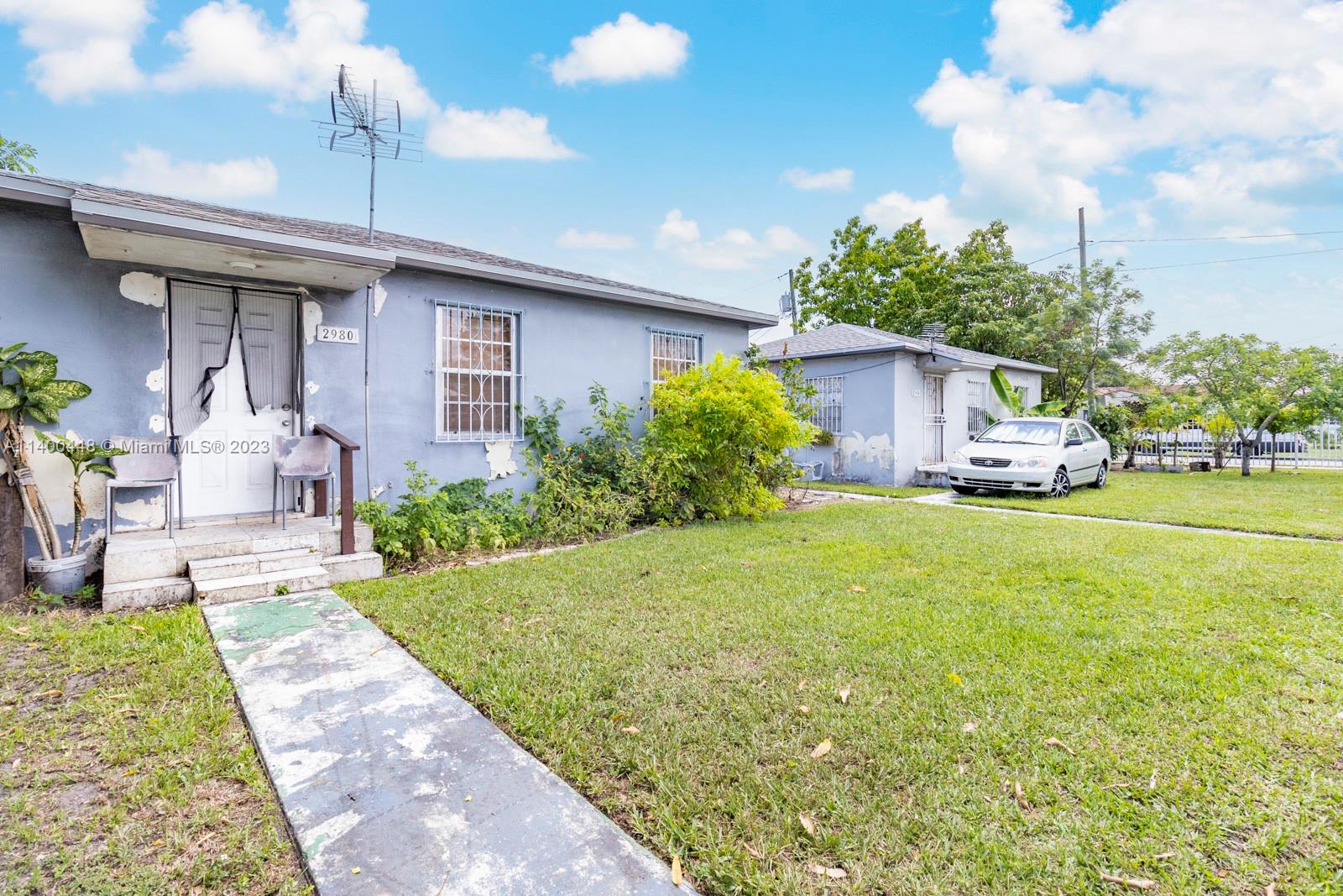 2990 Northwest 28th Street Miami, FL 33142 - Photo 11 of 13 a front view of a house with garden