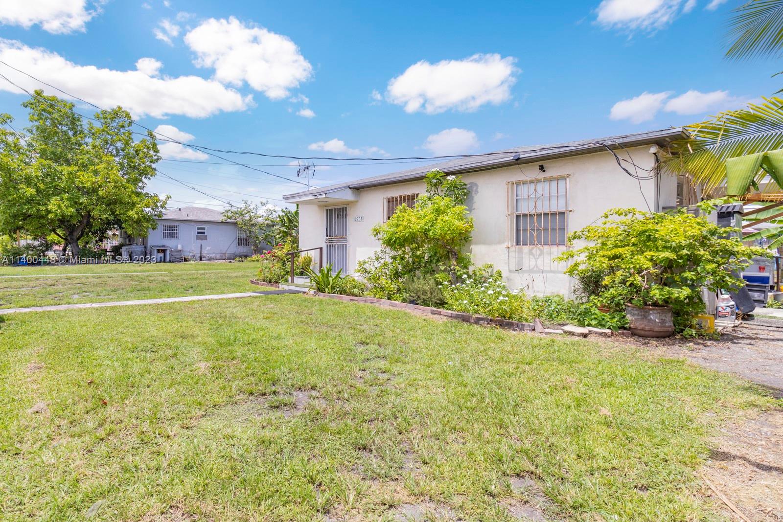 2990 Northwest 28th Street Miami, FL 33142 - Photo 13 of 13 a view of a house with a yard and potted plants