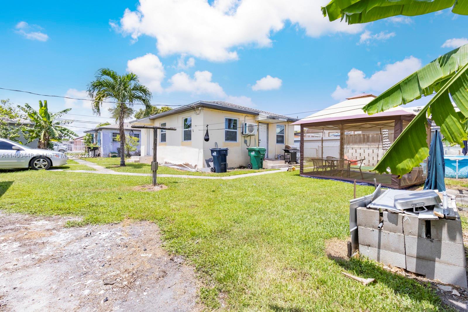 2990 Northwest 28th Street Miami, FL 33142 - Photo 2 of 13 a front view of a house with garden