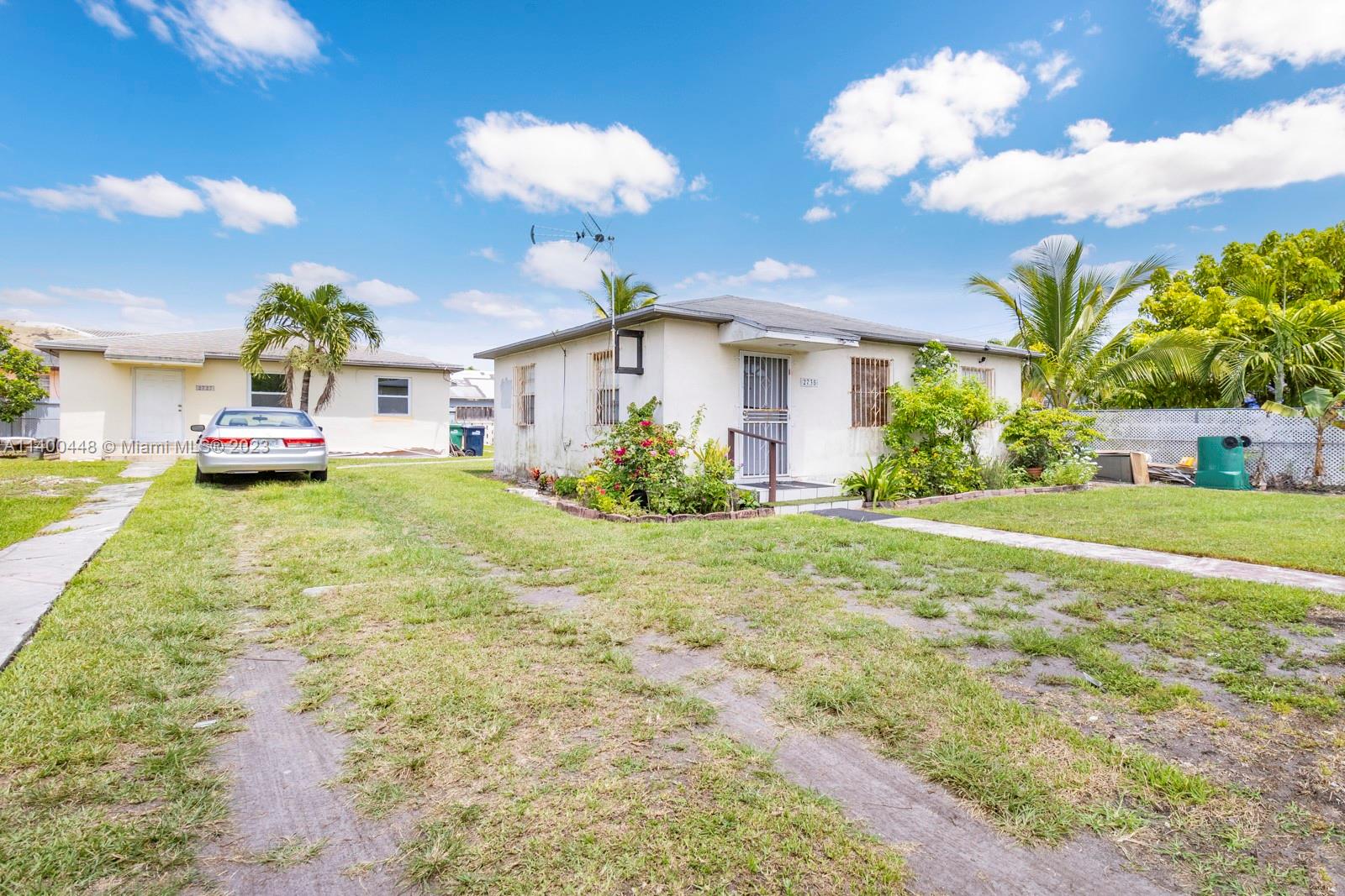 2990 Northwest 28th Street Miami, FL 33142 - Photo 4 of 13 a view of a house with a big yard and large trees