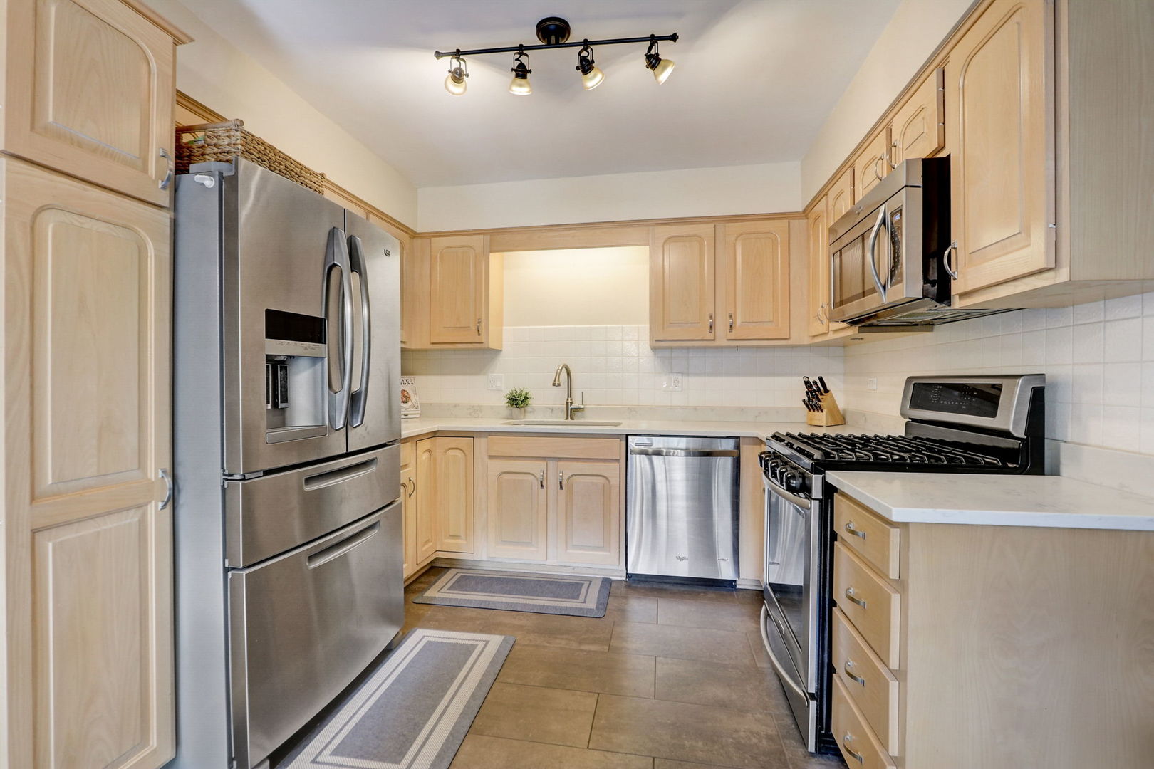 1514 Applegate Drive Naperville, IL 60565 - Photo 11 of 51 a kitchen with stainless steel appliances granite countertop a refrigerator sink and stove