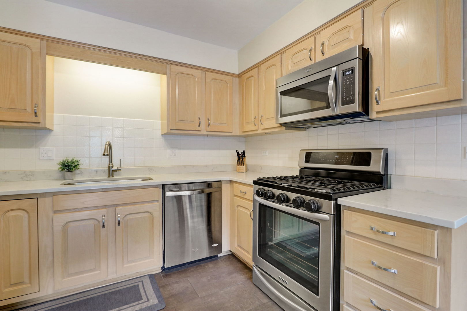 1514 Applegate Drive Naperville, IL 60565 - Photo 12 of 51 a kitchen with white cabinets and appliances
