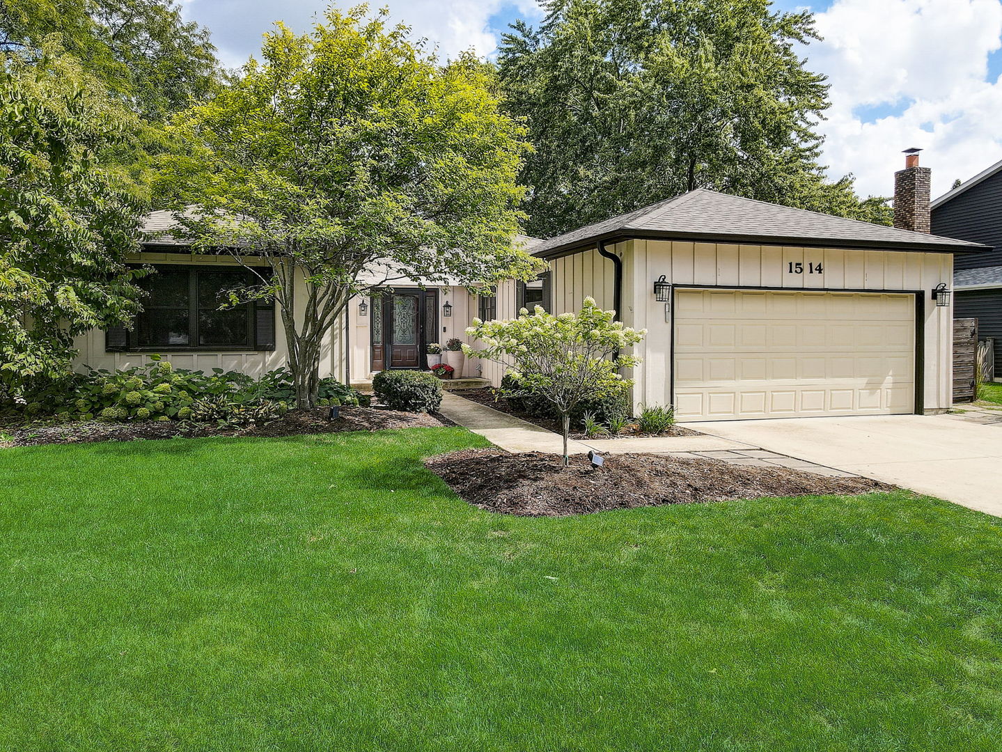 1514 Applegate Drive Naperville, IL 60565 - Photo 3 of 51 a front view of a house with a garden and plants