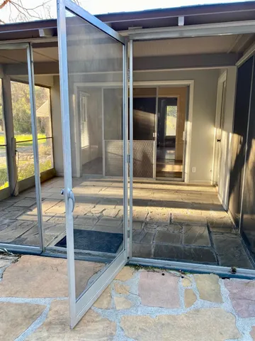 an empty room with windows and fireplace