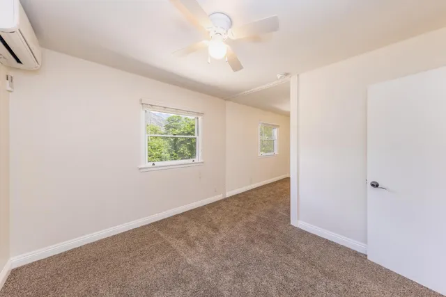 an empty room with windows and closet