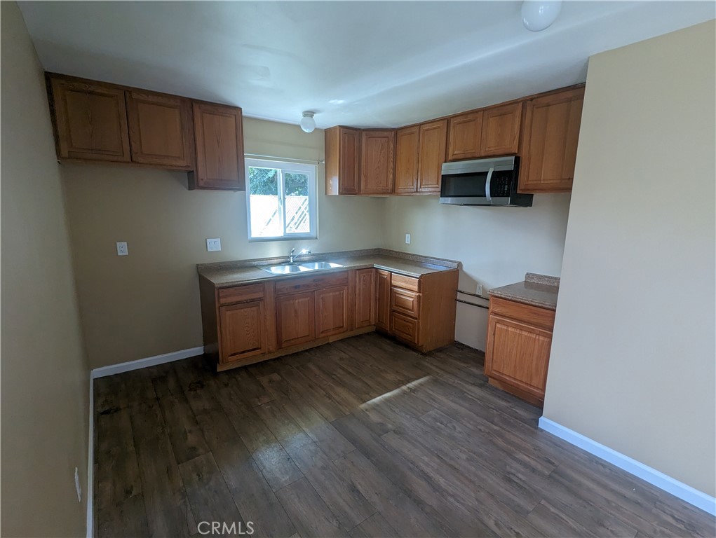 9330-9332 Saffron Court Riverside, CA 92503 - Photo 11 of 21 a kitchen with stainless steel appliances a sink cabinets and wooden floor