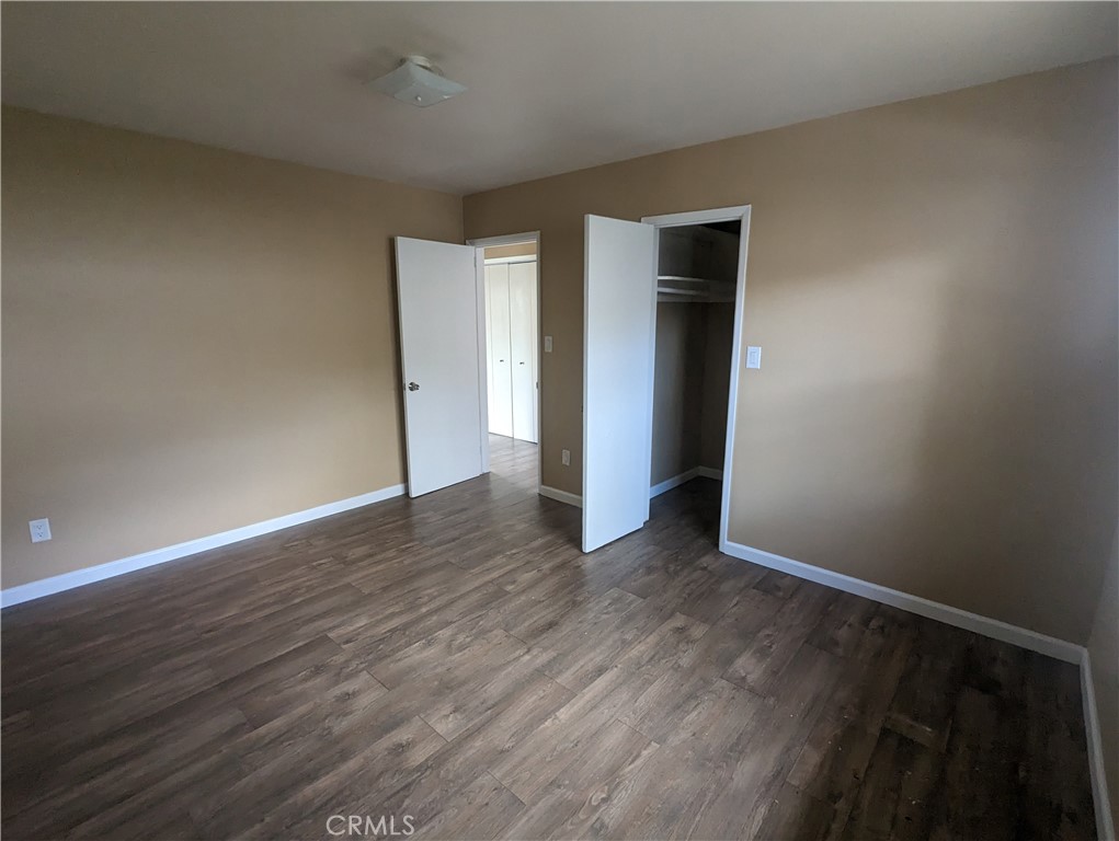 9330-9332 Saffron Court Riverside, CA 92503 - Photo 17 of 21 a view of an empty room with wooden floor and closet