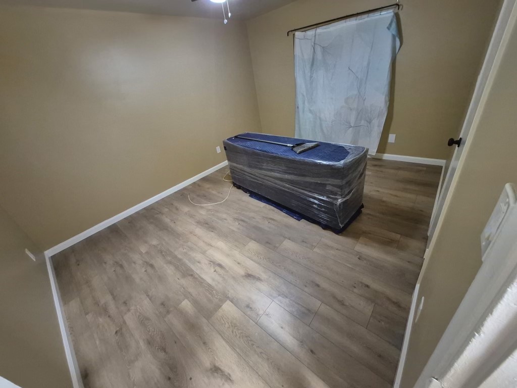 9330-9332 Saffron Court Riverside, CA 92503 - Photo 6 of 21 a room with a wooden floor and tub