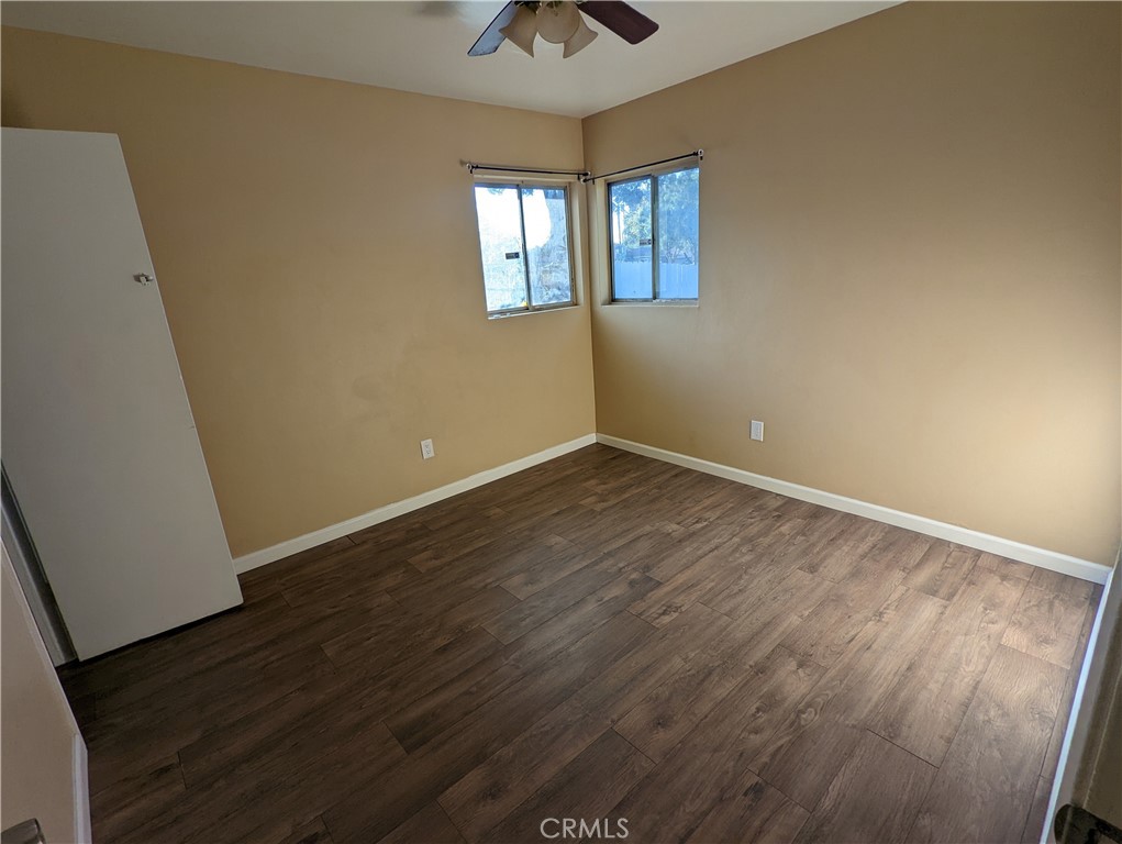 9330-9332 Saffron Court Riverside, CA 92503 - Photo 7 of 21 wooden floor in an empty room with a window