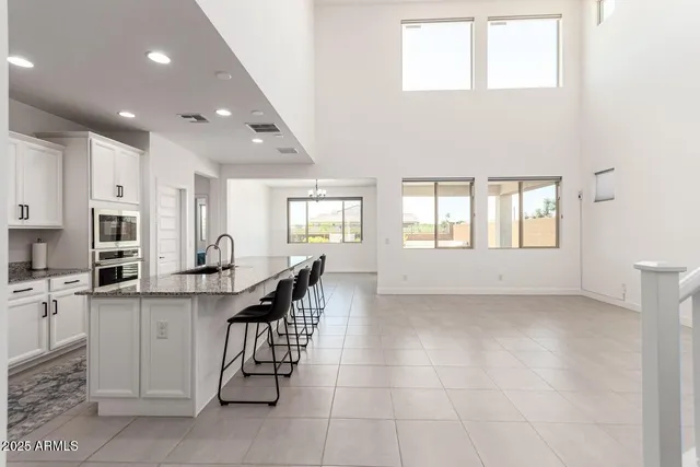 a kitchen area with lots of bottles of alcohol