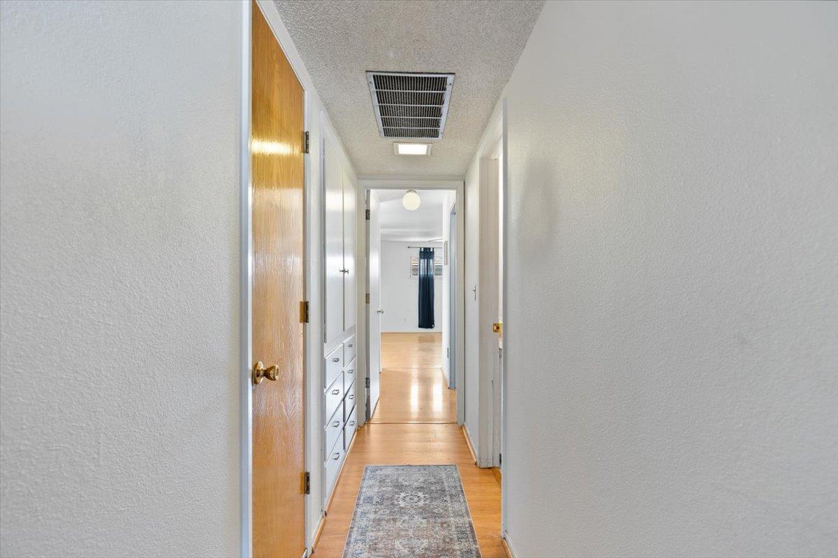 69 Springbrook Circle Sacramento, CA 95831 - Photo 21 of 29 a view of a hallway with wooden floor and living room