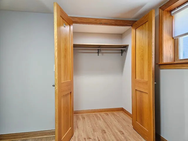 a view of walk in closet with empty room