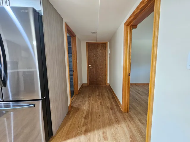 a view of hallway with wooden floor