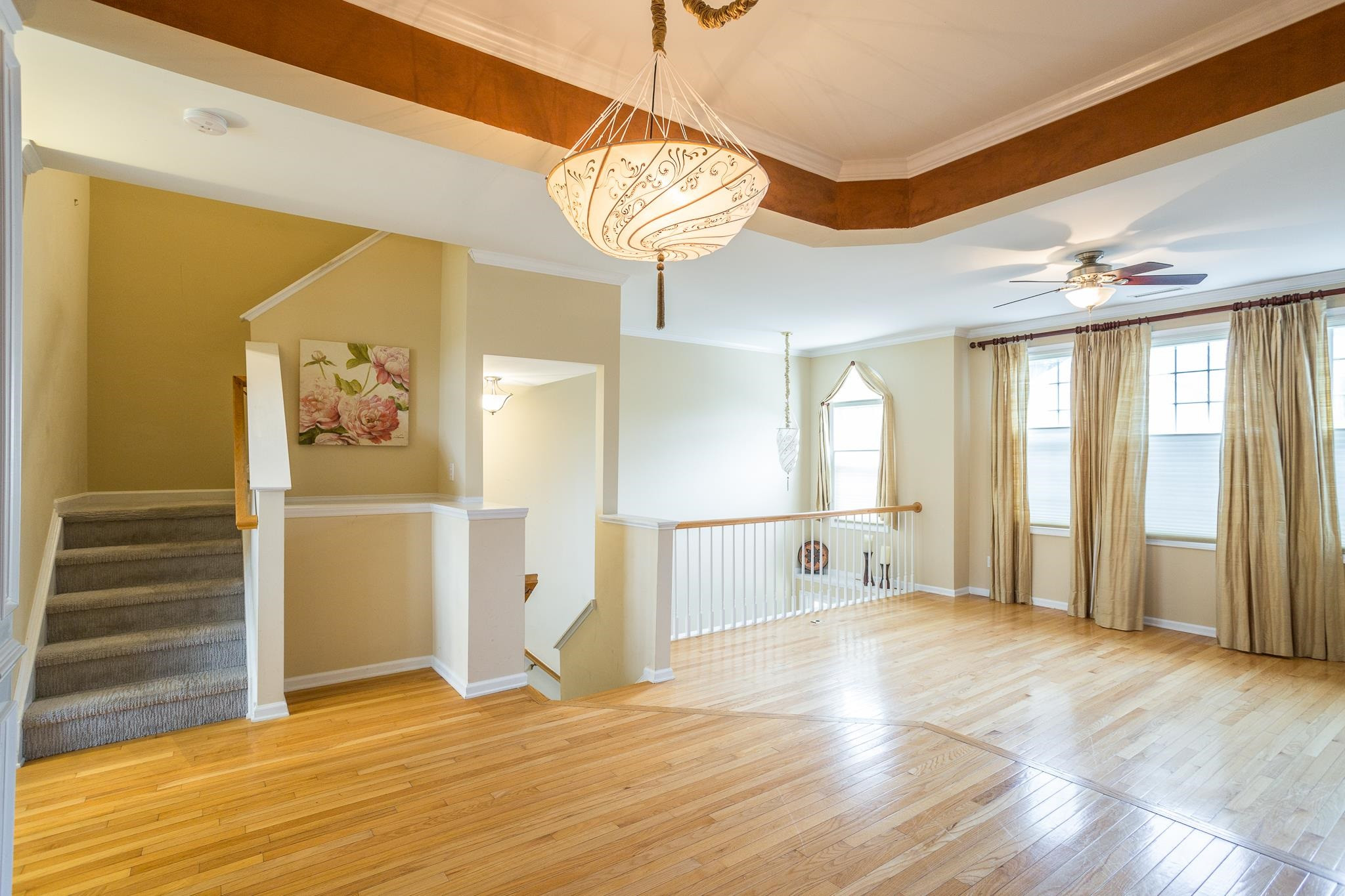 6905 Middleboro Drive Raleigh, NC 27612 - Photo 2 of 23 Hardwood floors stretch across the open concept layout; a perfect match for the large, bright windows and vaulted ceiling in the entryway. Living Room