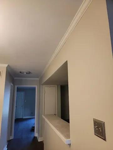 a view of hallway with wooden floor