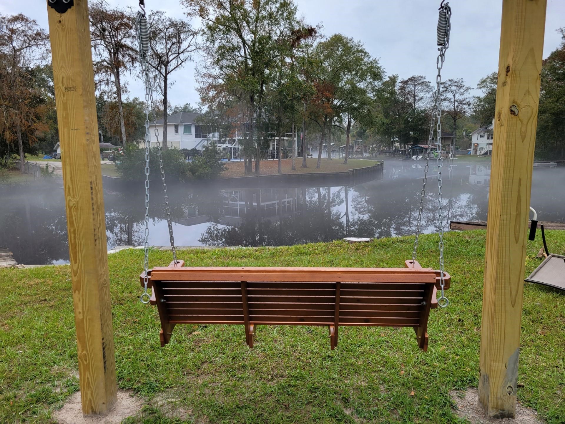 4057 Lazy Acres Road Middleburg, FL 32068 - Photo 10 of 15 a wooden bench sitting next to a lake