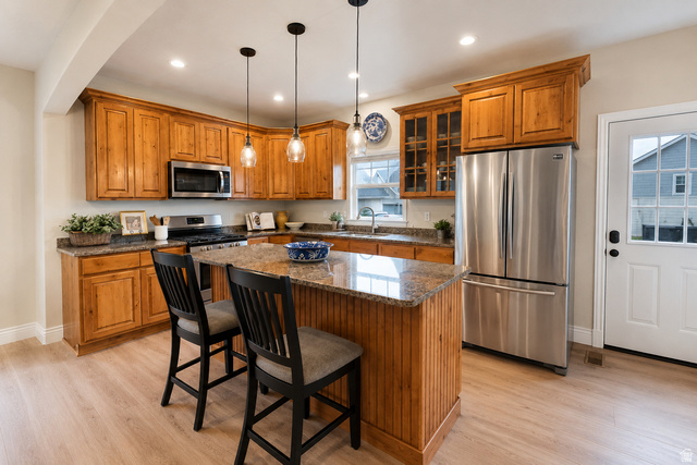 896 Cres Drive South Mapleton, UT 84664 - Photo 8 of 32 Kitchen featuring wood cabinetry, stainless steel appliances, granite countertops, a central island with beadboard detailing, and light wood-finish flooring