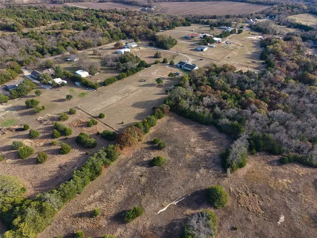 an aerial view of house with a yard