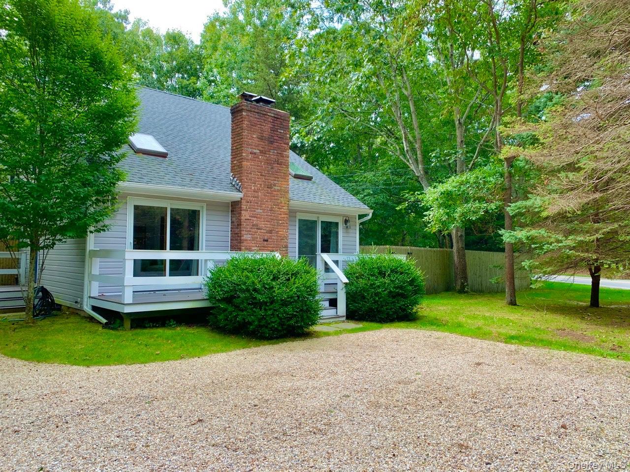 View of side of home featuring a shingled roof and a chimney