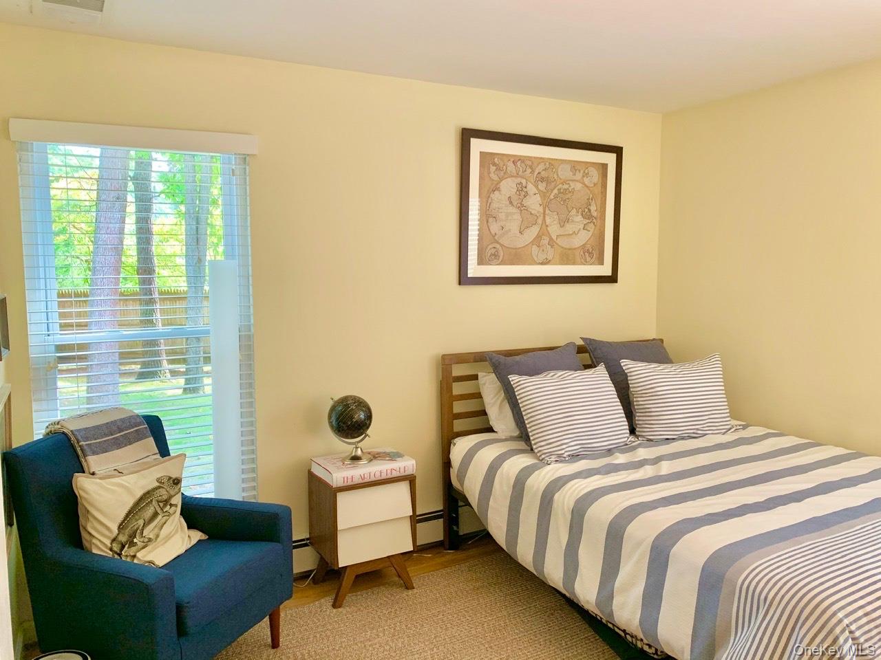 61 Kings Point Road East Hampton, NY 11937 - Photo 6 of 15 Bedroom with wood finished floors and a baseboard radiator