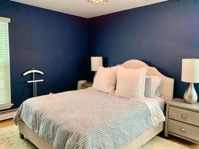 a bedroom with a bed and a lamp